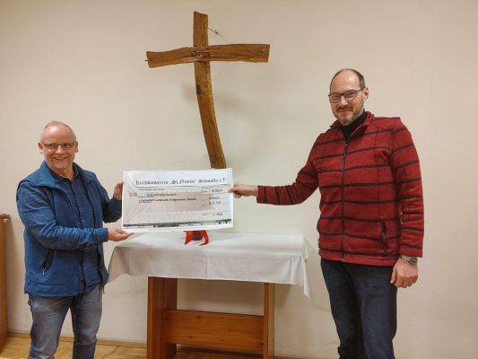 Pfarrer Thomas Eisner (links) erhält vom Vorsitzenden des Schmöllner Kirchbauvereins einen Scheck über 35.000 Euro für die Sanierung der Schmöllner Stadtkirche.